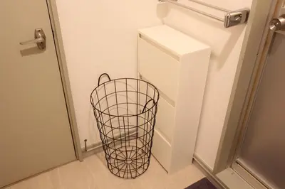 a refrigerator with a basket next to a door at LUANA ARAI in Tokyo