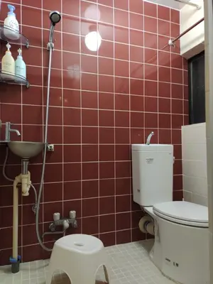 a red tiled bathroom with a toilet and a shower at \u85e4\u7d2bFujiMurasaki Japanese classic House in Tokyo