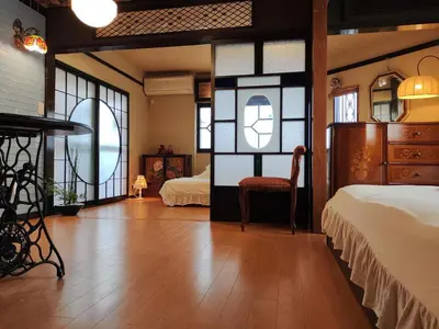 a bedroom with two beds and a table and chairs at \u85e4\u7d2bFujiMurasaki Japanese classic House in Tokyo