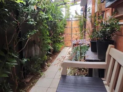 a small garden with a bench and plants at \u85e4\u7d2bFujiMurasaki Japanese classic House in Tokyo