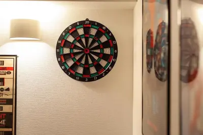 a dart board on a wall with a lamp at \u30e1\u30c7\u30a3\u30a2\u30b3\u30f3\u30d7\u30ec\u30c3\u30af\u30b9\u30d3\u30eb in Tokyo
