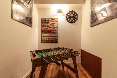 a game room with a dart board on the wall at \u30e1\u30c7\u30a3\u30a2\u30b3\u30f3\u30d7\u30ec\u30c3\u30af\u30b9\u30d3\u30eb in Tokyo