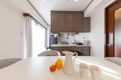 a kitchen with a white table with two oranges on it at \u30e1\u30c7\u30a3\u30a2\u30b3\u30f3\u30d7\u30ec\u30c3\u30af\u30b9\u30d3\u30eb in Tokyo
