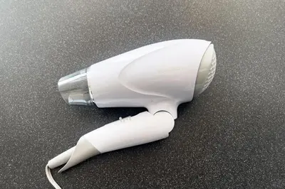 a white hair dryer sitting on the floor at \u30c8\u30ea\u30a2\u30b9540 in Tokyo