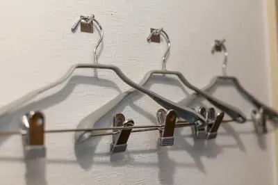 a group of three metal hooks hanging on a wall at \u30b5\u30f3\u30d1\u30ec\u30b9\u897f\u65b0\u5bbf in Tokyo