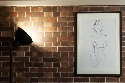 a drawing of a woman on a wall next to a lamp at Nsk\u30d3\u30eb in Tokyo