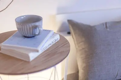 a cup on top of a stack of books on a table at \u30b7\u30e3\u30c8\u30ec\u897f\u5927\u4e95 in Tokyo
