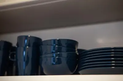 a group of blue cups sitting on a shelf at \u90fd\u5fc3\u7e01\u6e0b\u8c37 in Tokyo