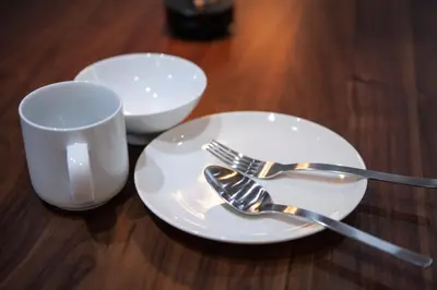 a plate with a fork and a cup on a table at \u30e1\u30be\u30f3\u516d\u672c\u6728 in Tokyo