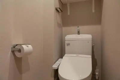 a bathroom with a white toilet with a remote control at \u30e1\u30be\u30f3\u516d\u672c\u6728 in Tokyo