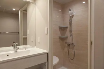 a bathroom with a shower with a sink and a toilet at \u30e1\u30be\u30f3\u516d\u672c\u6728 in Tokyo