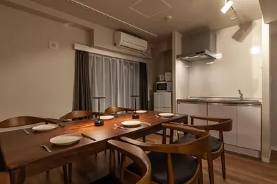 a dining room with a wooden table and chairs at \u30e1\u30be\u30f3\u516d\u672c\u6728 in Tokyo