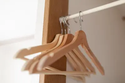 a group of wooden hangers hanging from a wall at \u30d2\u30eb\u30ba\u99d2\u8fbc in Tokyo