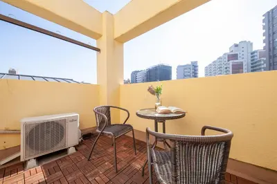 a balcony with a table and two chairs and a heater at \u30d2\u30eb\u30ba\u99d2\u8fbc in Tokyo