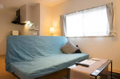 a bedroom with a bed and a table and a window at \u30ab\u30fc\u30b5\u30de\u30c4\u30d0\u30e9 in Tokyo