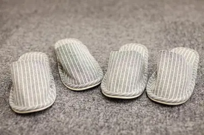 three pairs of flip flops sitting on the floor at \u7b2c\u4e09\u5929\u53f0\u30d3\u30eb in Tokyo