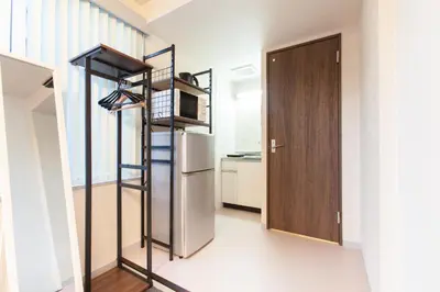 a kitchen with a staircase and a refrigerator in a room at \u7b2c\u4e09\u5929\u53f0\u30d3\u30eb in Tokyo