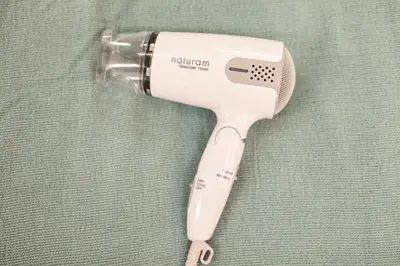 a hair dryer sitting on top of a cloth at \u7b2c\u4e09\u5929\u53f0\u30d3\u30eb in Tokyo