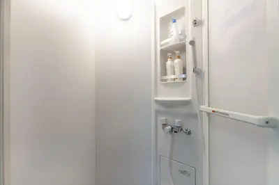 an open refrigerator door with bottles in it at \u7b2c\u4e09\u5929\u53f0\u30d3\u30eb in Tokyo