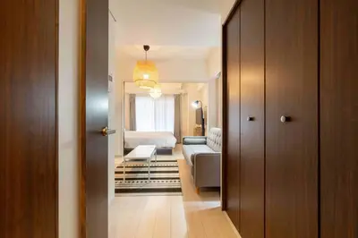 a hallway leading to a living room with a couch at Tokyo Sunshine Tower in Tokyo