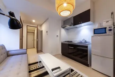 a small kitchen with a couch and a table in a room at Tokyo Sunshine Tower in Tokyo