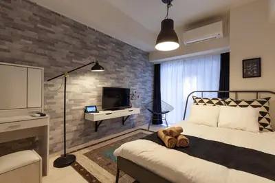 a bedroom with a bed with a teddy bear on it at Tokyo Sunshine Tower in Tokyo