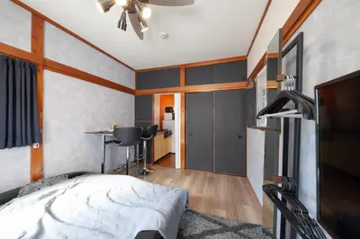 a bedroom with a bed and a desk in it at \u690e\u540d\u753a\u30cf\u30a6\u30b9 in Tokyo
