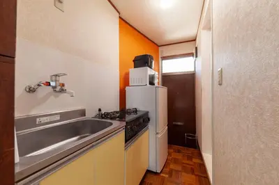 a small kitchen with a sink and a refrigerator at \u690e\u540d\u753a\u30cf\u30a6\u30b9 in Tokyo