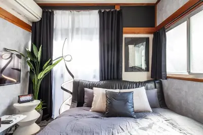 a bedroom with a bed and a window at \u690e\u540d\u753a\u30cf\u30a6\u30b9 in Tokyo