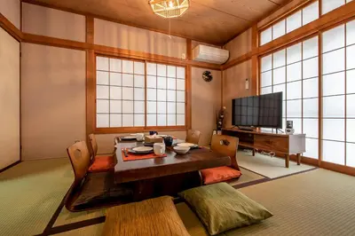 a living room with a table and a tv at \u5e61\u30f6\u8c373\u4e01\u76ee\u6238\u5efa in Tokyo