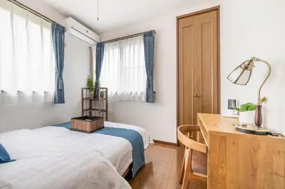 a bedroom with a bed and a desk and window at \u5e61\u30f6\u8c373\u4e01\u76ee\u6238\u5efa in Tokyo