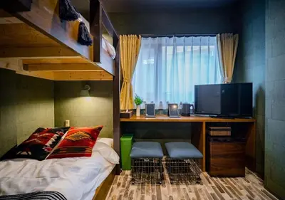 a bedroom with a bunk bed and a desk with a television at IKIDANE Residentila Hotel Komagome - Vacation STAY 17962v in Tokyo