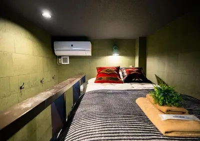 a room with two beds and a tv on the wall at IKIDANE Residentila Hotel Komagome - Vacation STAY 17962v in Tokyo
