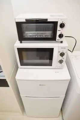 a microwave oven sitting on top of three drawers at \u30d7\u30ec\u30df\u30a2\u30e0\u30b3\u30fc\u30c8\u897f\u6c60\u888b in Tokyo