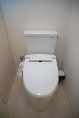 a bathroom with a white toilet with a remote control at \u30d7\u30ec\u30df\u30a2\u30e0\u30b3\u30fc\u30c8\u897f\u6c60\u888b in Tokyo