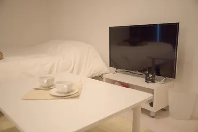 a white table with two cups and a tv on it at \u30d7\u30ec\u30df\u30a2\u30e0\u30b3\u30fc\u30c8\u897f\u6c60\u888b in Tokyo