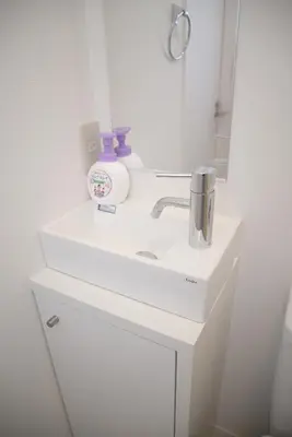 a bathroom with a white sink and a mirror at \u30d7\u30ec\u30df\u30a2\u30e0\u30b3\u30fc\u30c8\u897f\u6c60\u888b in Tokyo