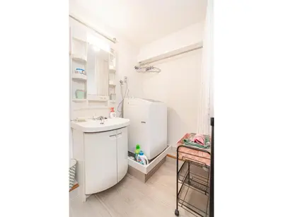 a small kitchen with a sink and a refrigerator at Ikebukuro East Exit Queen Bed Room in Tokyo