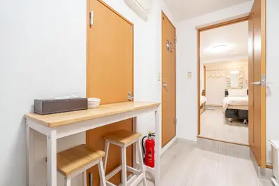 a kitchen with a counter and a room with a bed at Ikebukuro East Exit Queen Bed Room in Tokyo