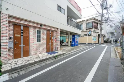 an empty street next to a brick building at Ikebukuro East Exit Queen Bed Room in Tokyo