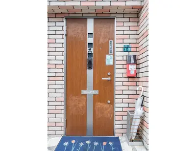a wooden door on a brick building with a sign on it at Ikebukuro East Exit Queen Bed Room in Tokyo