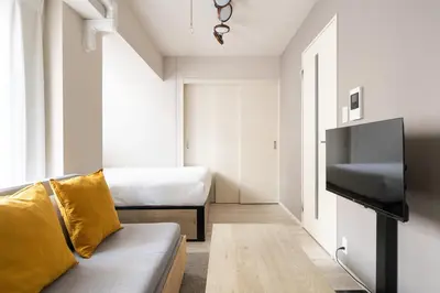 a living room with a couch and a tv at Lafesta\u6771\u99d2\u5f62 in Tokyo