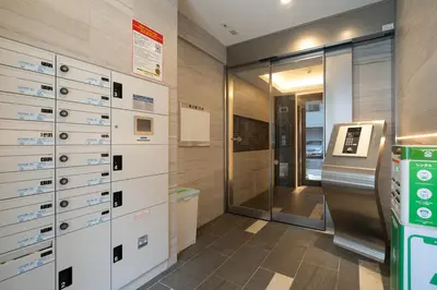 a bathroom with white drawers and a glass elevator at Lafesta\u6771\u99d2\u5f62 in Tokyo