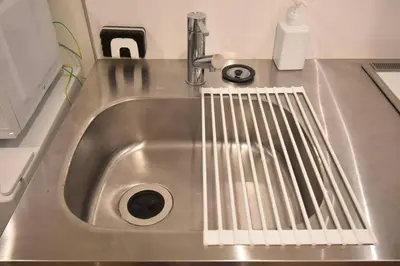 a stainless steel sink with a drain in it at \u6771\u99d2\u5f62101 in Tokyo