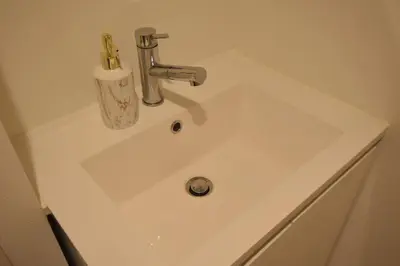 a white bathroom sink with a soap dispenser on it at \u6771\u99d2\u5f62102 in Tokyo
