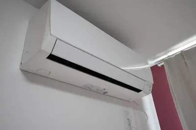 a white printer hanging from a ceiling at \u6771\u99d2\u5f62103 in Tokyo