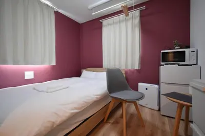 a small bedroom with a bed and a chair at \u6771\u99d2\u5f62103 in Tokyo
