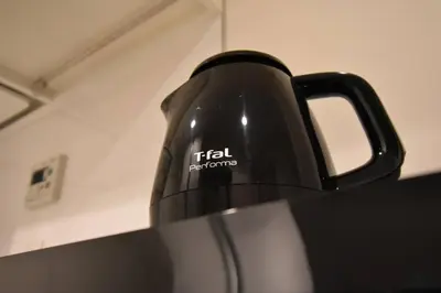 a black tea kettle sitting on top of a counter at \u6771\u99d2\u5f62201 in Tokyo
