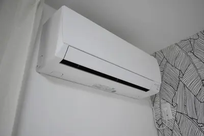 a white printer sitting on top of a wall at \u6771\u99d2\u5f62201 in Tokyo