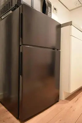 a stainless steel refrigerator in a kitchen at \u6771\u99d2\u5f62201 in Tokyo